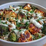 Warm, nourishing Roasted Brassica Bowl features charred Brussels sprouts, tender broccoli, and crisp cauliflower over hearty grains, topped with savory pumpkin seeds and fresh parsley.