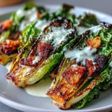 Warm grilled Caesar salad with crisp croutons and shaved Parmesan cheese pictured.