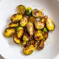Golden, crispy Roasted Brussels Sprouts, perfectly caramelized with a delicious, nutty flavor, ready to eat.