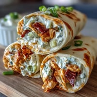 Creamy Buffalo chicken and cheese rolled in soft tortillas, perfect for easy party appetizers or game day snacks.