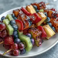 Rainbow Fruit Skewers with Honey Dip: colorful, fresh fruit arranged in rainbow order on skewers, served with a creamy honey-yogurt dip for a vibrant, healthy treat.